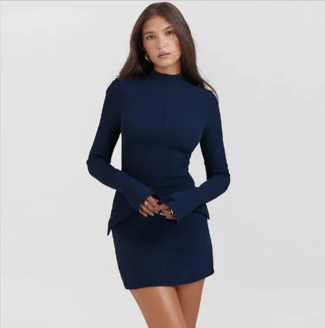 Woman wearing a navy blue slimline midi dress with long sleeves and a high neckline.
