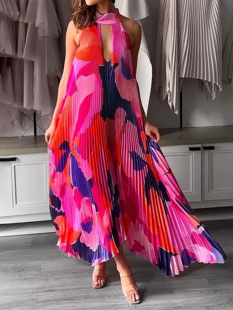 "Sleeveless A-line pleated dress in red, pink, and navy floral print with halter-style top and keyhole front cutout."