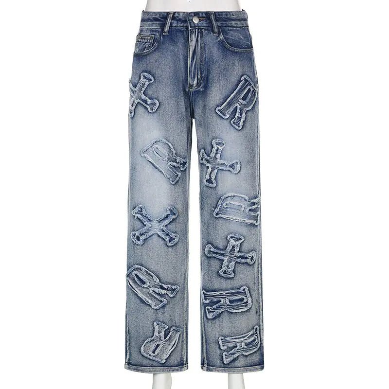 Front view of blue straight-leg jeans with large distressed alphabet letter appliqués.