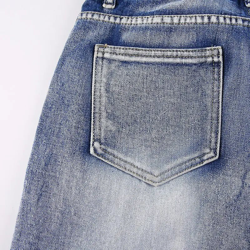 Close-up of a single back pocket with faded wash detail on the jeans.