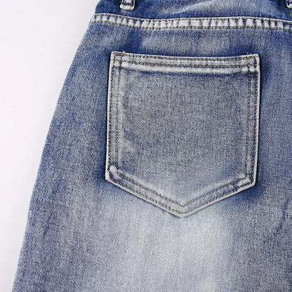 Close-up of a single back pocket with faded wash detail on the jeans.