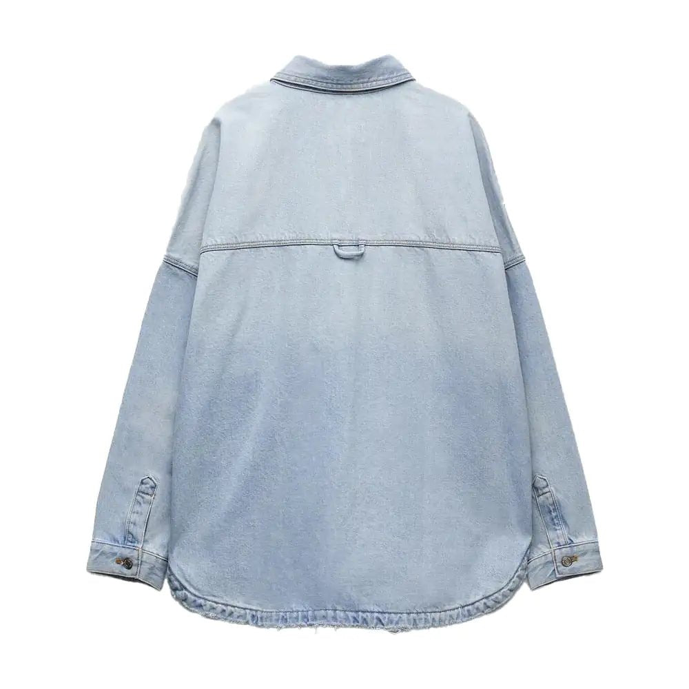 Flat lay of the back of a light blue denim shirt jacket with simple stitching.