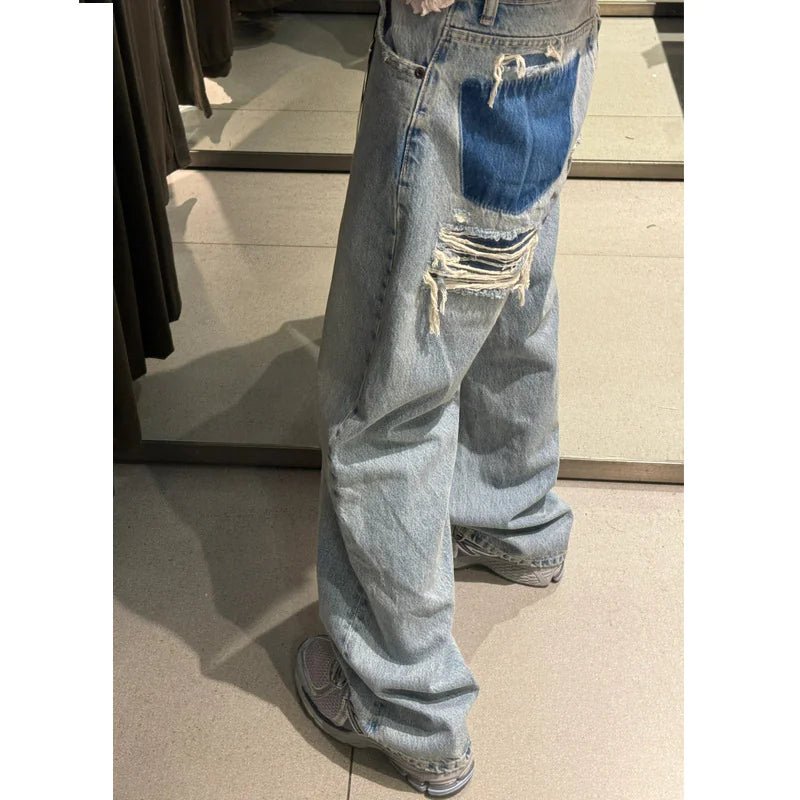 Light blue ripped wide-leg jeans with contrast denim patch on pocket