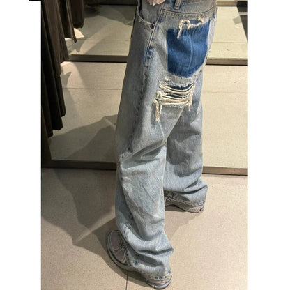 Light blue ripped wide-leg jeans with contrast denim patch on pocket