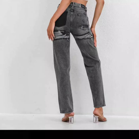 High-waisted gray distressed straight leg jeans with raw hem, styled with heeled sandals