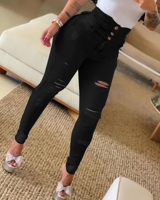High-rise black skinny jeans with distressed accents and triple-button front closure