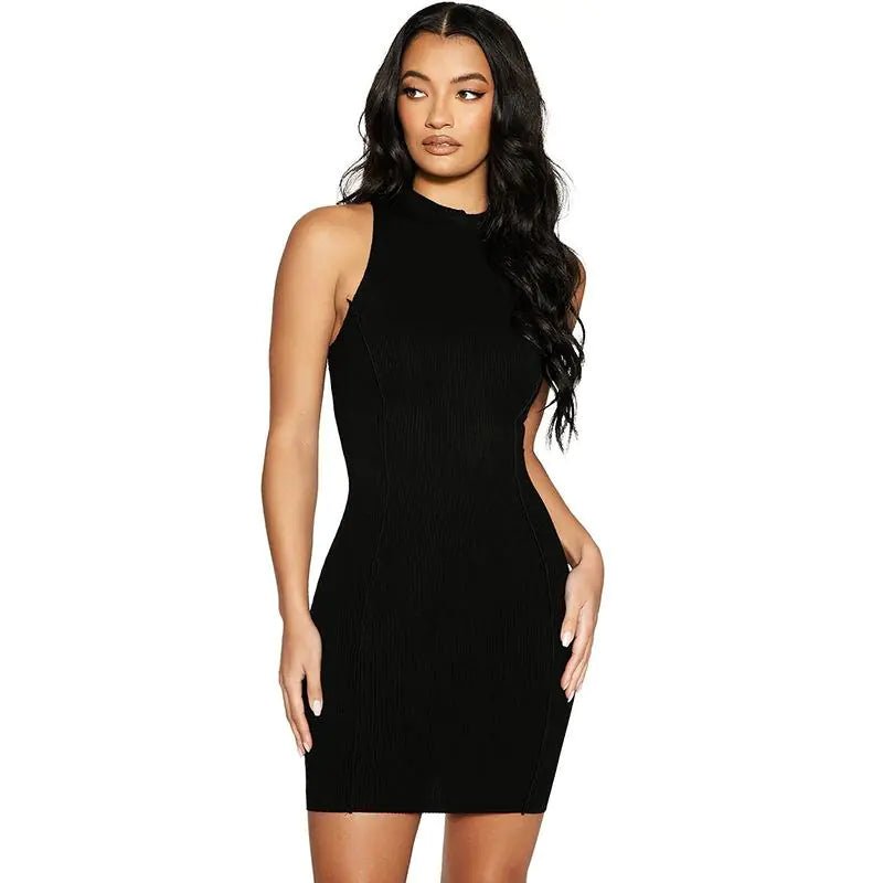 Woman wearing a sleeveless black ribbed halter mini dress with a fitted silhouette, posing confidently.
