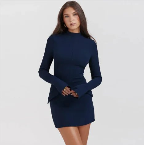 Woman wearing a navy blue slimline midi dress with long sleeves and a high neckline.