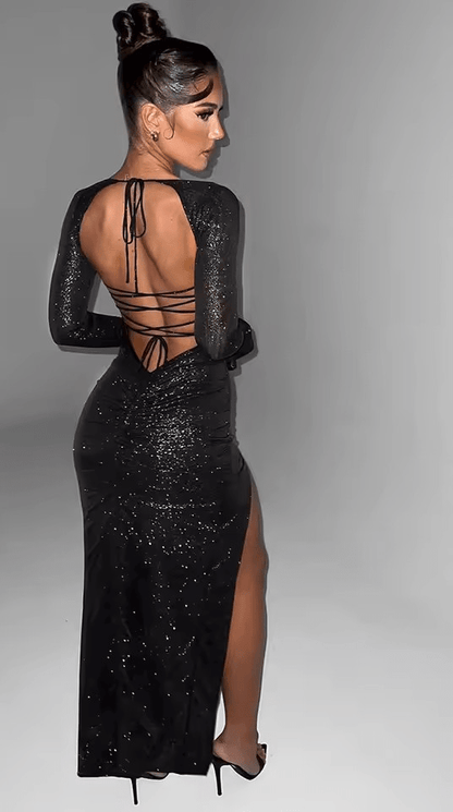 Back view of the black long sleeve evening dress showcasing the open back with crisscross lace-up detailing.