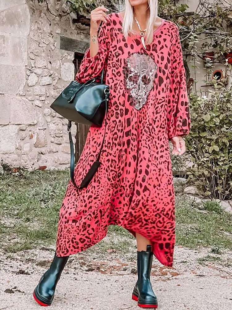 "Bold pink leopard print maxi dress featuring a sequin skull patch on the front, loose fit with long sleeves and a relaxed boho style."