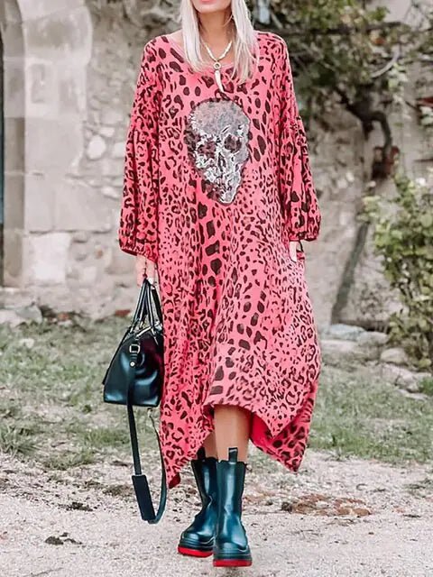 "Bold pink leopard print maxi dress featuring a sequin skull patch on the front, loose fit with long sleeves and a relaxed boho style."