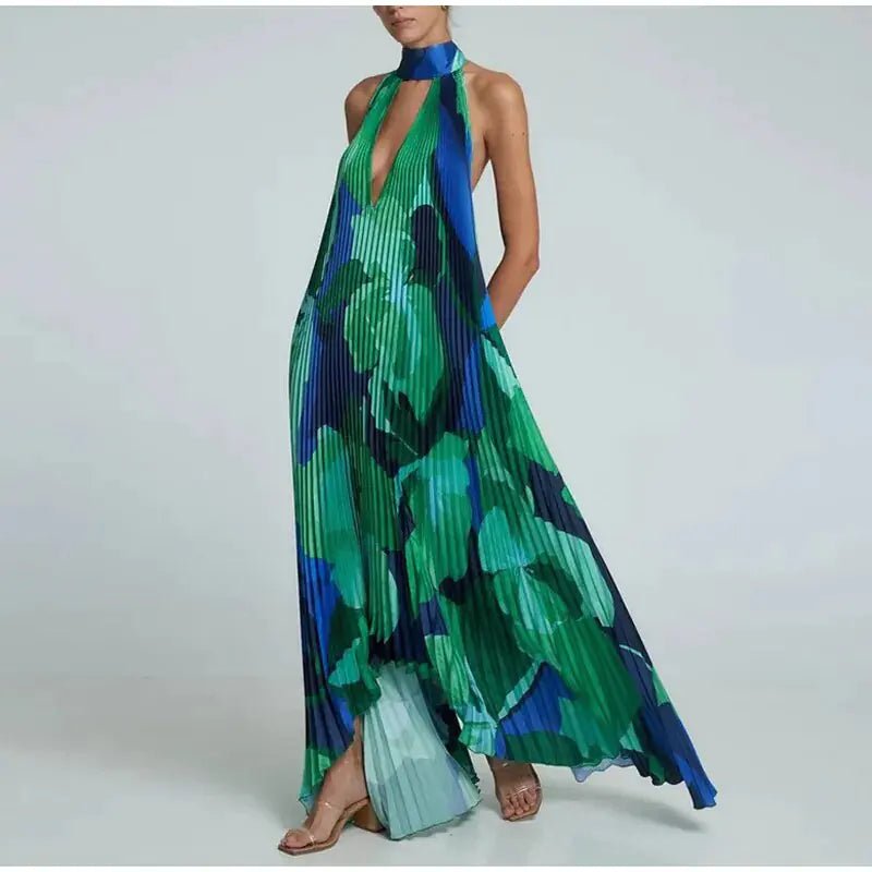 "Flowy sleeveless maxi dress with green and blue abstract floral print, featuring a deep V-neck and halter neckline."
