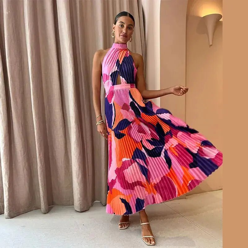 "Vibrant pink and purple sleeveless pleated midi dress with halter neckline and bold abstract floral pattern."