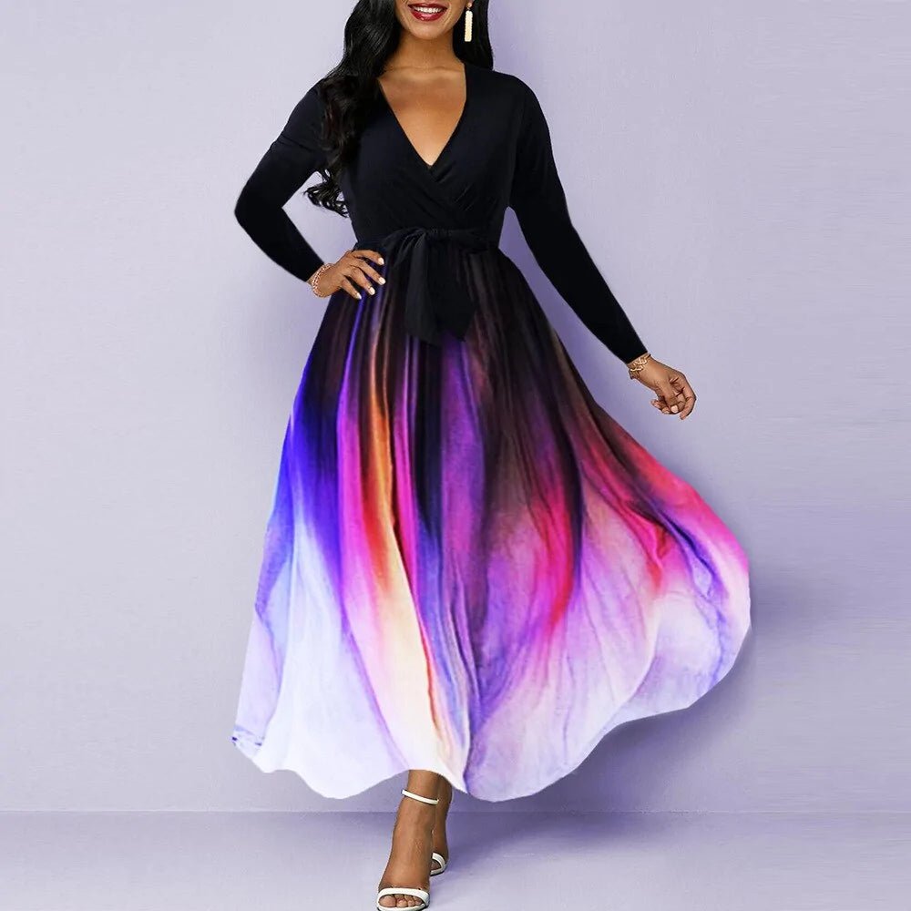 Elegant woman wearing a V-neck long sleeve maxi dress with a black top and a flowing multicolor gradient skirt in shades of purple, pink, and white.