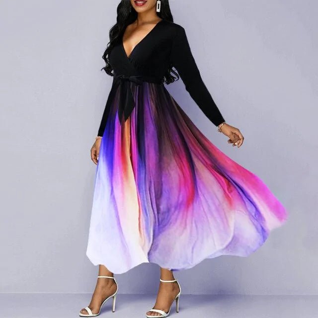 Elegant woman wearing a V-neck long sleeve maxi dress with a black top and a flowing multicolor gradient skirt in shades of purple, pink, and white.