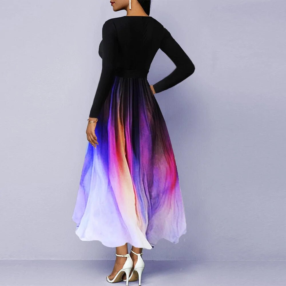 Elegant woman wearing a V-neck long sleeve maxi dress with a black top and a flowing multicolor gradient skirt in shades of purple, pink, and white.