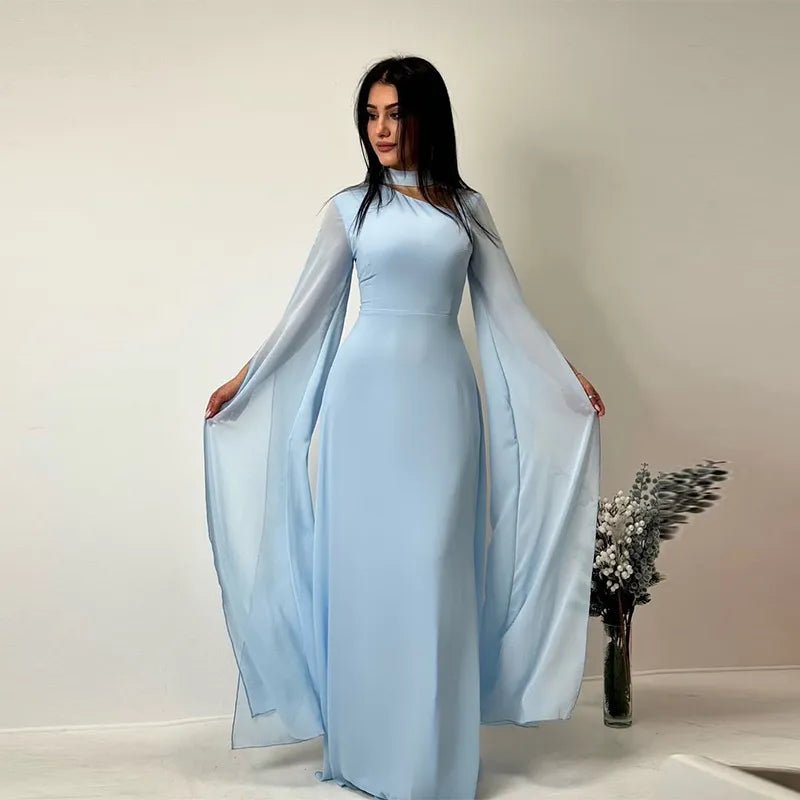Graceful light blue long-sleeve evening gown with sheer cape-like sleeves, styled for a soft and dreamy look.