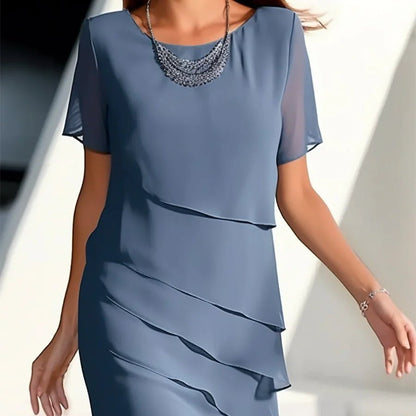Elegant women's chiffon patchwork dress in vibrant blue, with cascading layers and a soft silhouette, perfect for formal occasions.