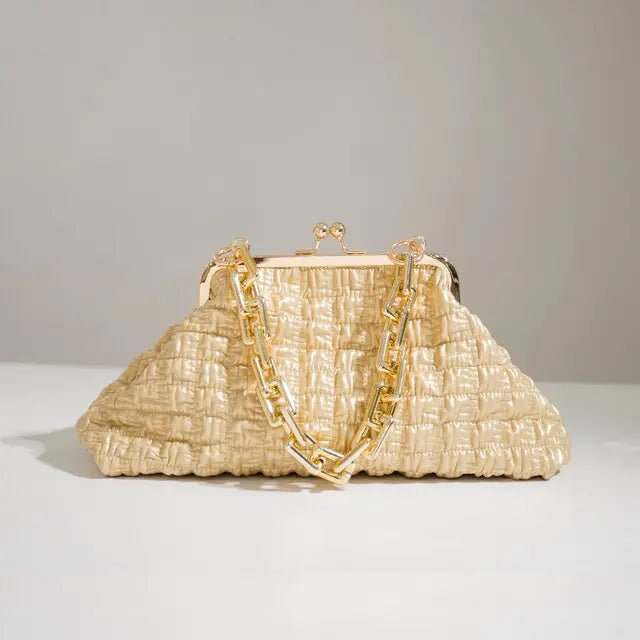 Beige pleated handbag with gold chain on a grey background.