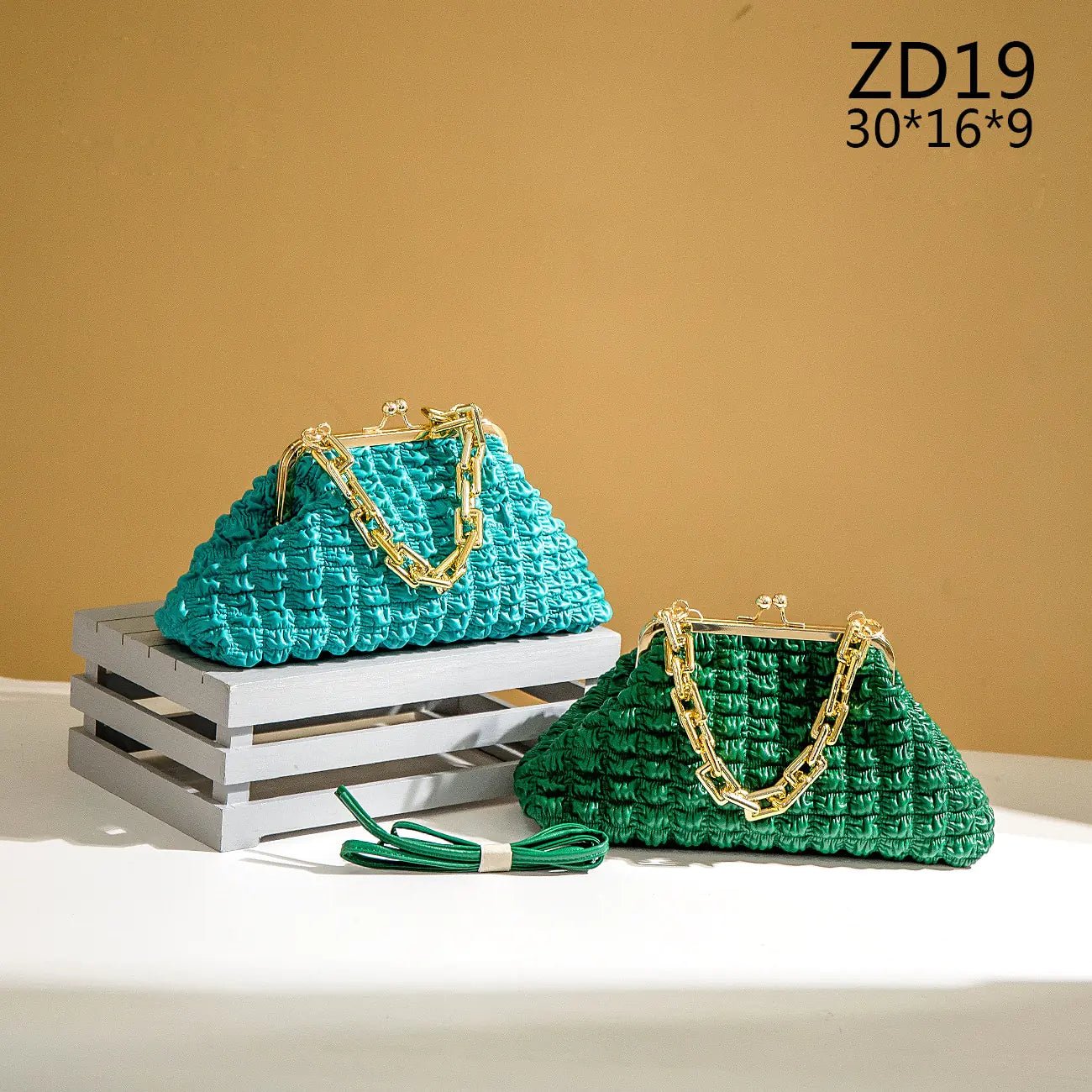 Light blue pleated handbags with gold chains displayed in two sizes.