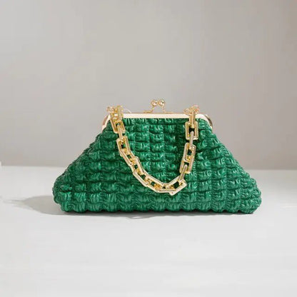 Dark green pleated handbag with chain strap on light grey surface.