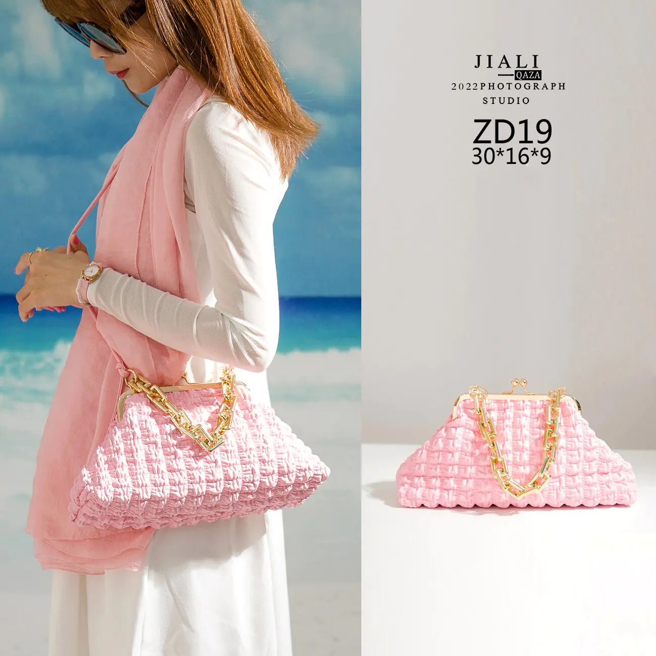 Model in blue holding pink pleated handbag by the chain.