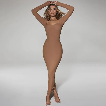 Woman wearing a brown long sleeve square neck bodycon dress posing barefoot with hands overhead.