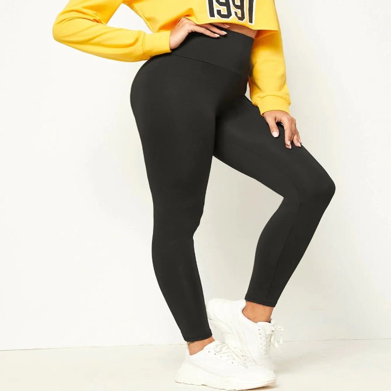 Side view of a woman wearing black leggings and a yellow sweatshirt, ideal for fitness, sports, or casual wear."

