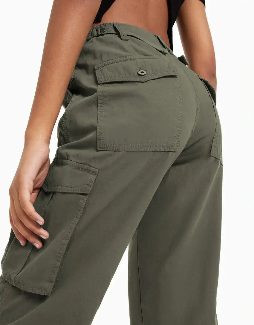 Close-up back view of dark green cargo trousers featuring utility pockets and reinforced stitching.