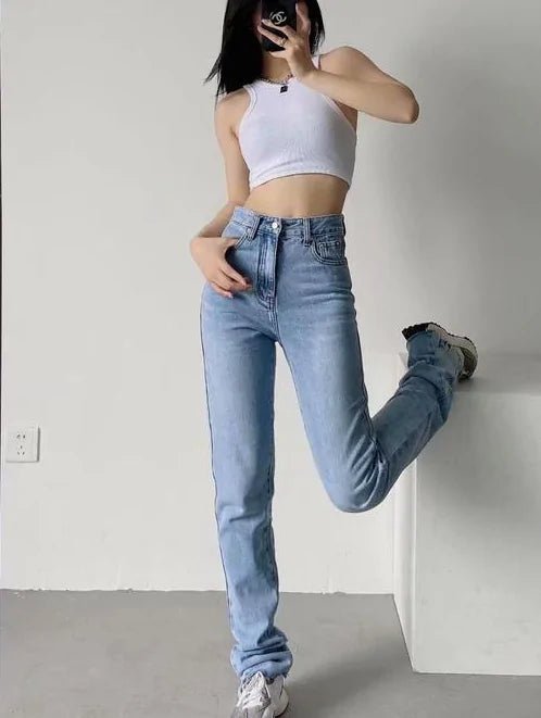 "Model wearing high-rise sculpting jeans in light blue with casual athletic pose"
