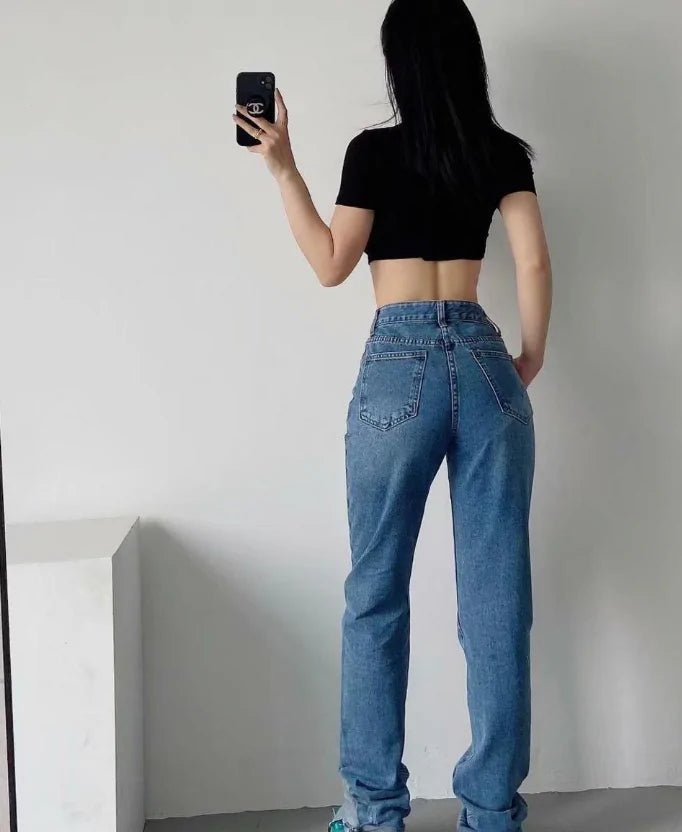 "Back view of sculpting high-rise jeans with classic pockets and tapered fit"