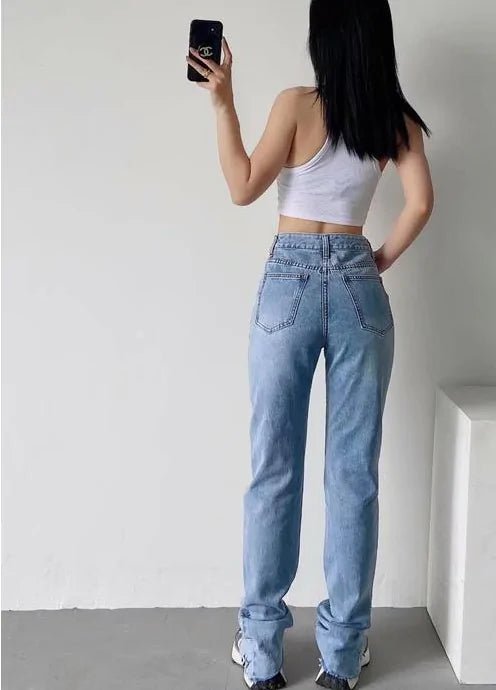 "Rear walking pose of model in light blue high-rise sculpting jeans"