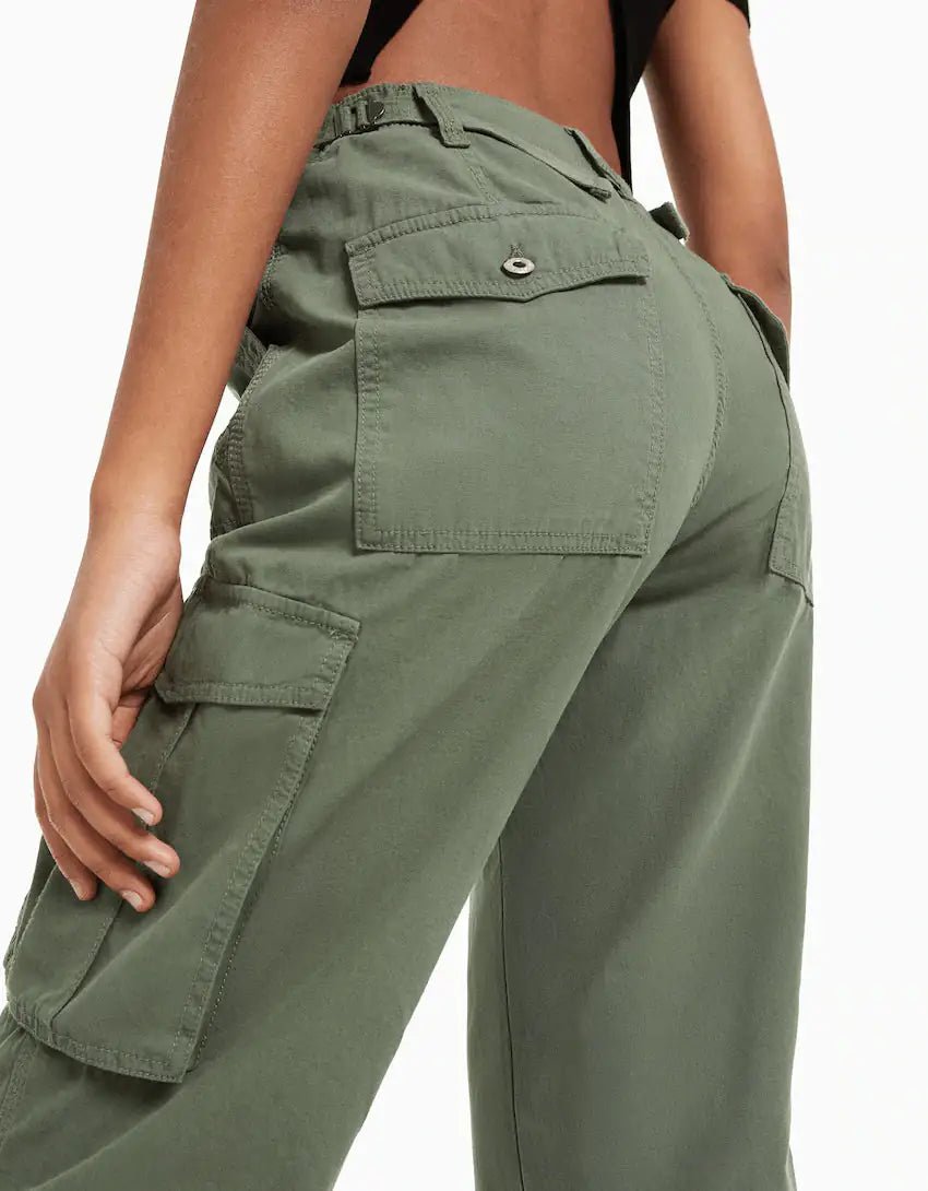 Close-up back view of dark green cargo trousers featuring utility pockets and reinforced stitching.