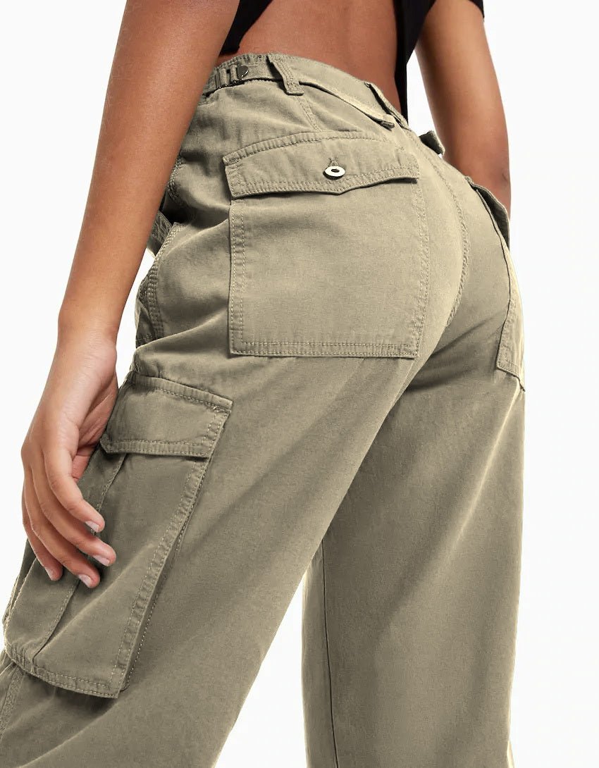 Close-up back view of olive green cargo trousers with flap pockets and seam detailing.