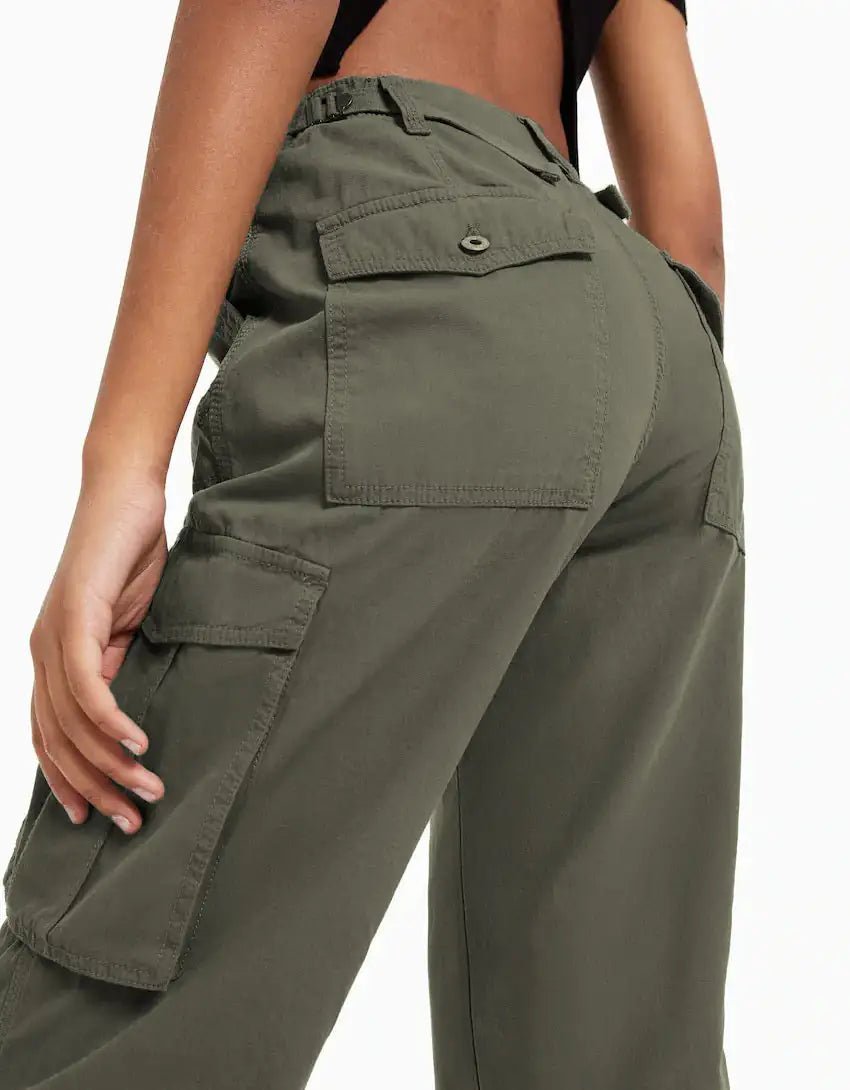 Close-up back view of dark green cargo trousers featuring utility pockets and reinforced stitching.