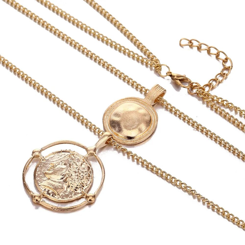  Detailed close-up of the gold vintage necklace showing the textured finish of the pendants and fine chain design.