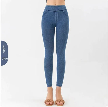 Front view of a woman wearing blue high-waist denim leggings, emphasizing the form-fitting design.