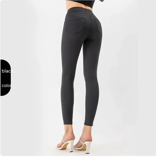 Back view of black high-waist denim leggings showing sculpted fit and curve-enhancing design.